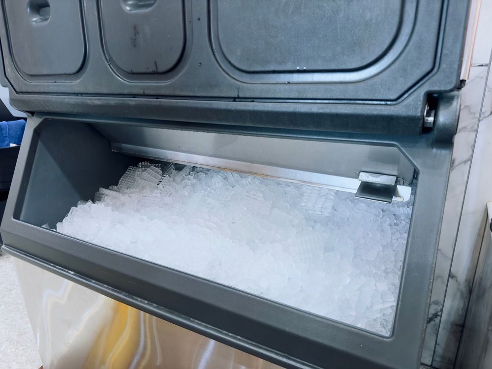 A container filled with ice is sitting on a table.