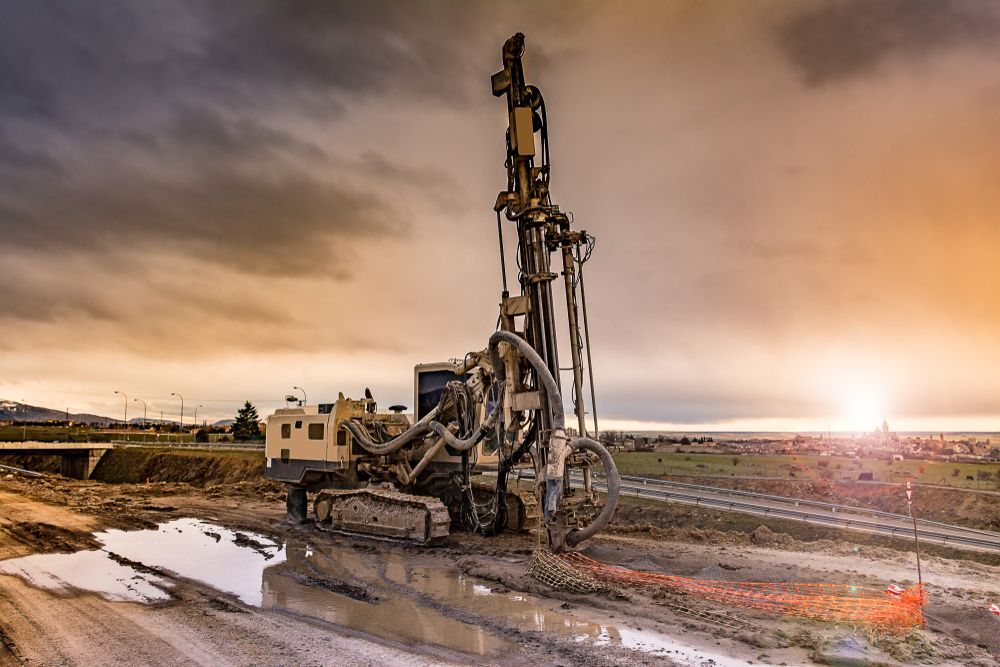 Drilling Rig on a Muddy Construction Site Under a Cloudy Sky — NRG Drilling in Maryborough, QLD