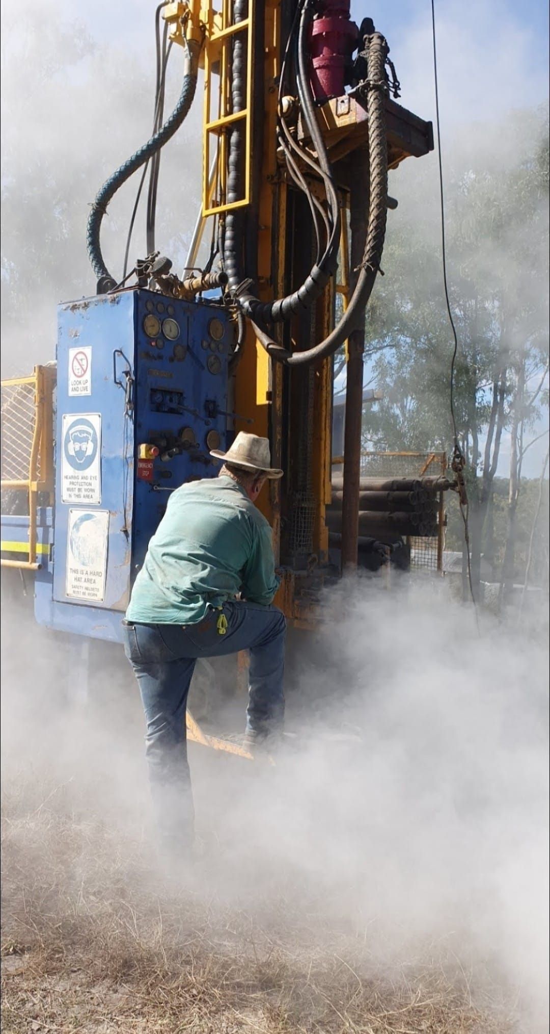 Man Operating a Drilling Rig, Surrounded by Dust — NRG Drilling in Calico Creek, QLD