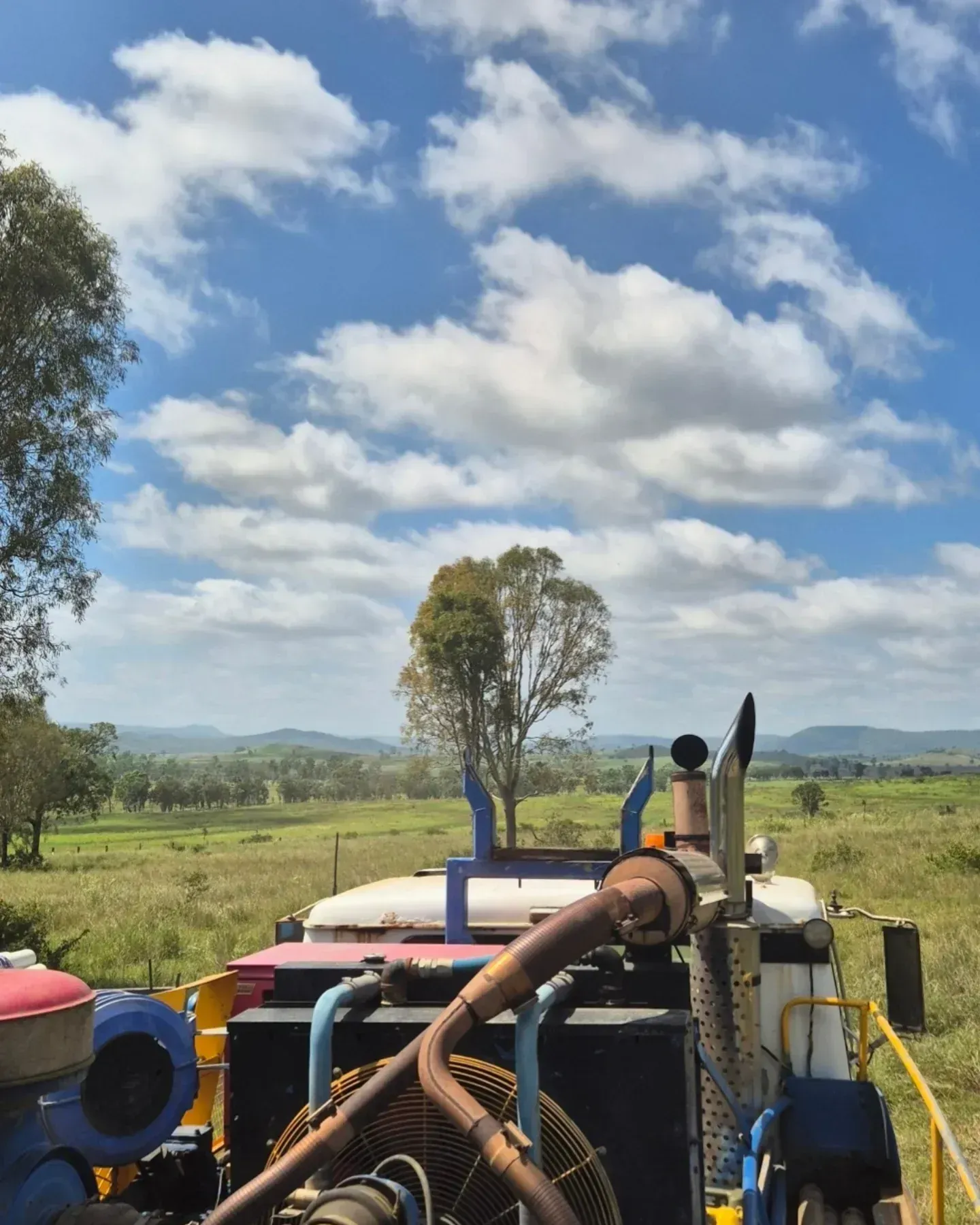Back of a Truck in a Field With Blue Sky and Scattered Clouds — NRG Drilling in Calico Creek, QLD