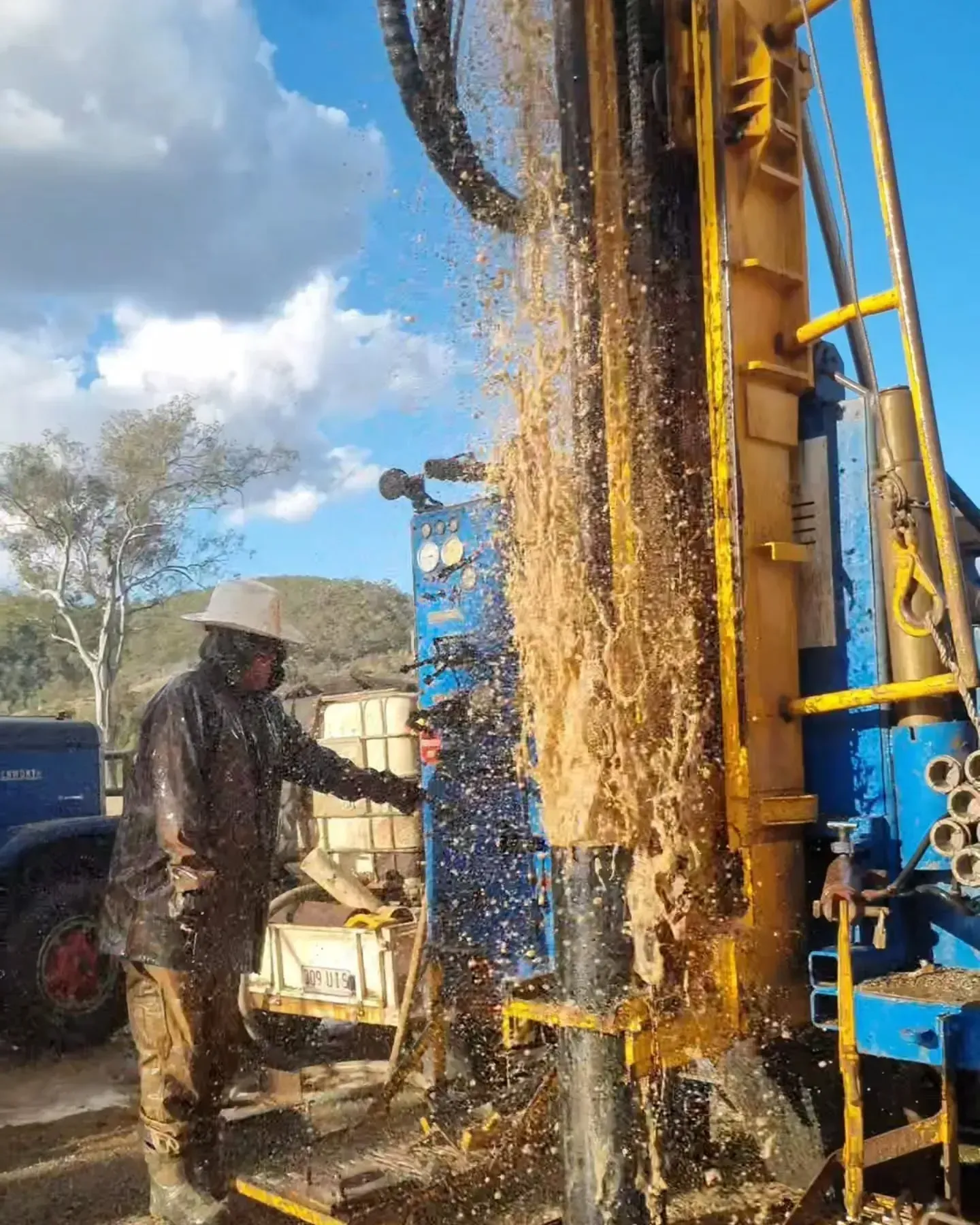 Person Operating a Drilling Rig, Mud Spraying — NRG Drilling in Calico Creek, QLD