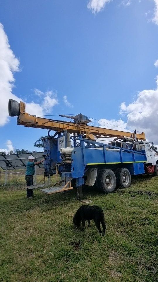 Blue and Yellow Drilling Rig on a Truck in a Field — NRG Drilling in Calico Creek, QLD