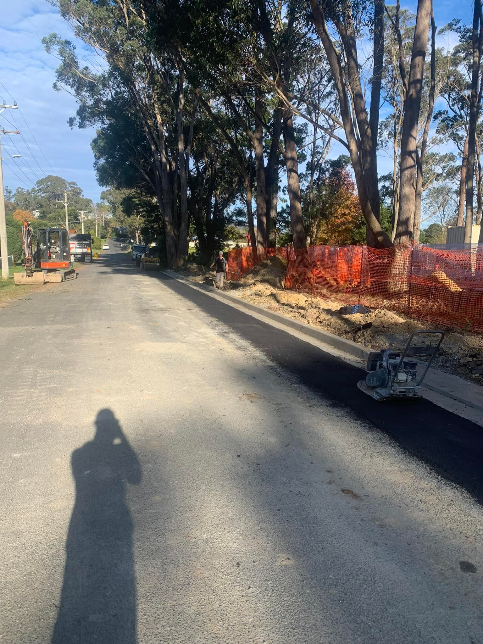 Asphalt road with construction barriers and equipment. Flushed Away Plumbing in Bowral