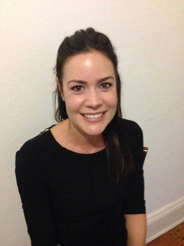 woman smiling and wearing black