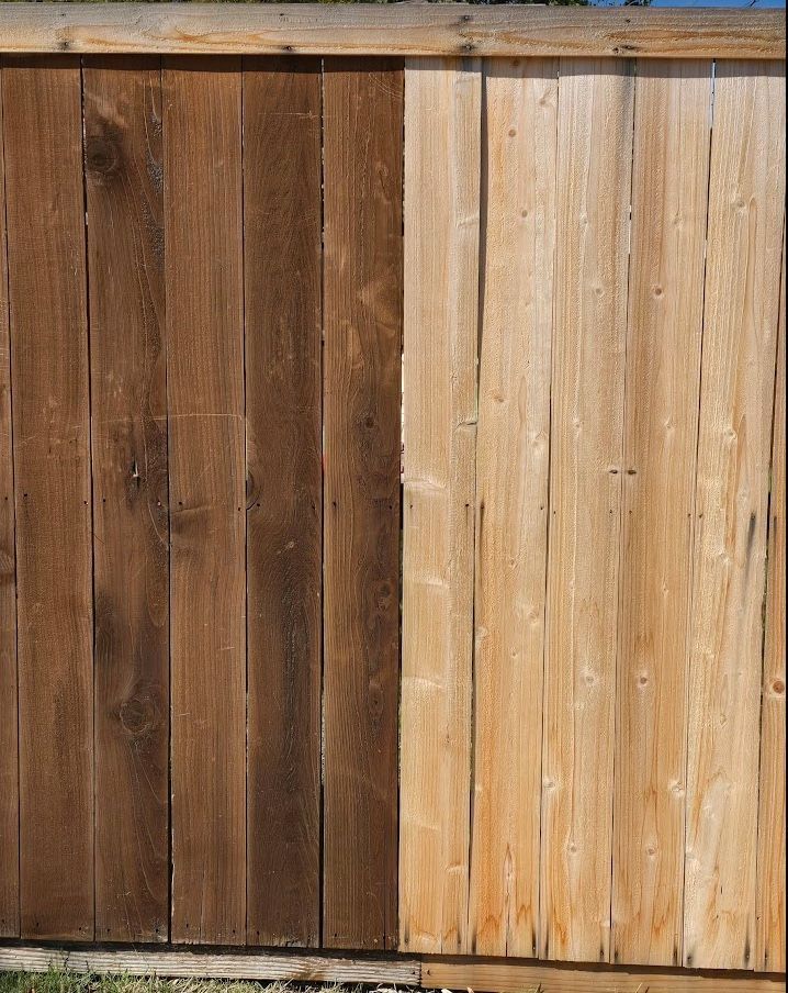 It is picture of a wooden fence showing a stained fence and a unstained fence.