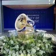 Gramophone trophy on a flower-filled stage with a blue “Legacy of Music” backdrop