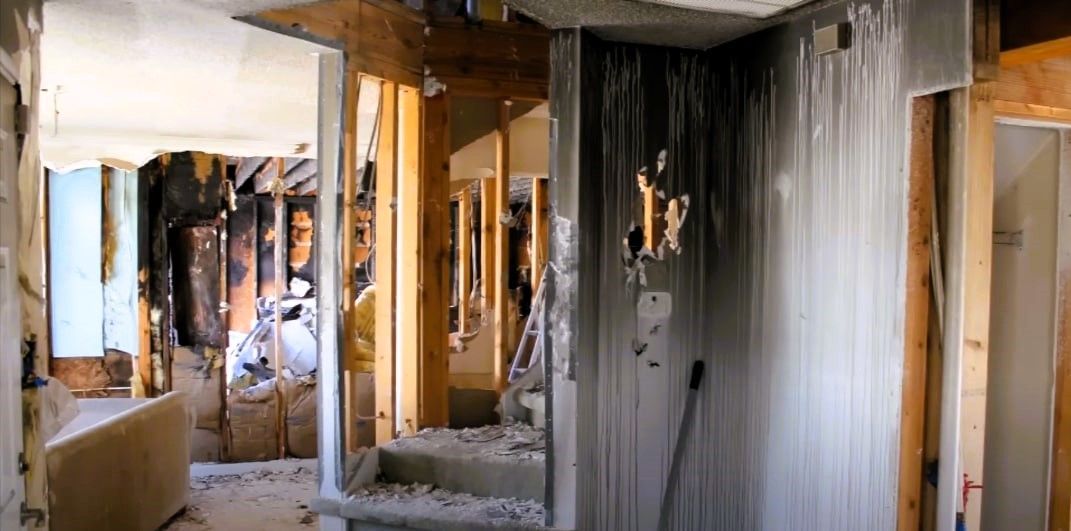 Fire-damaged house interior with mold growth