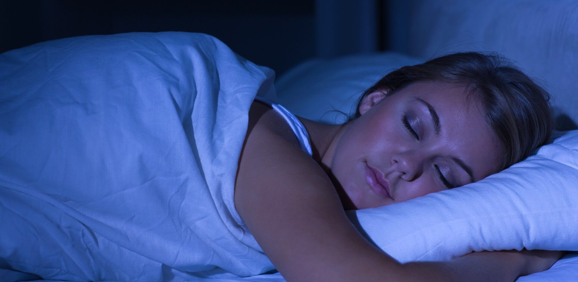 Woman sleeping in a bedroom not knowing that mold growth in the area might affect her quality of sleep