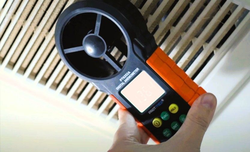 Measuring airflow with a digital anemometer during a mold inspection