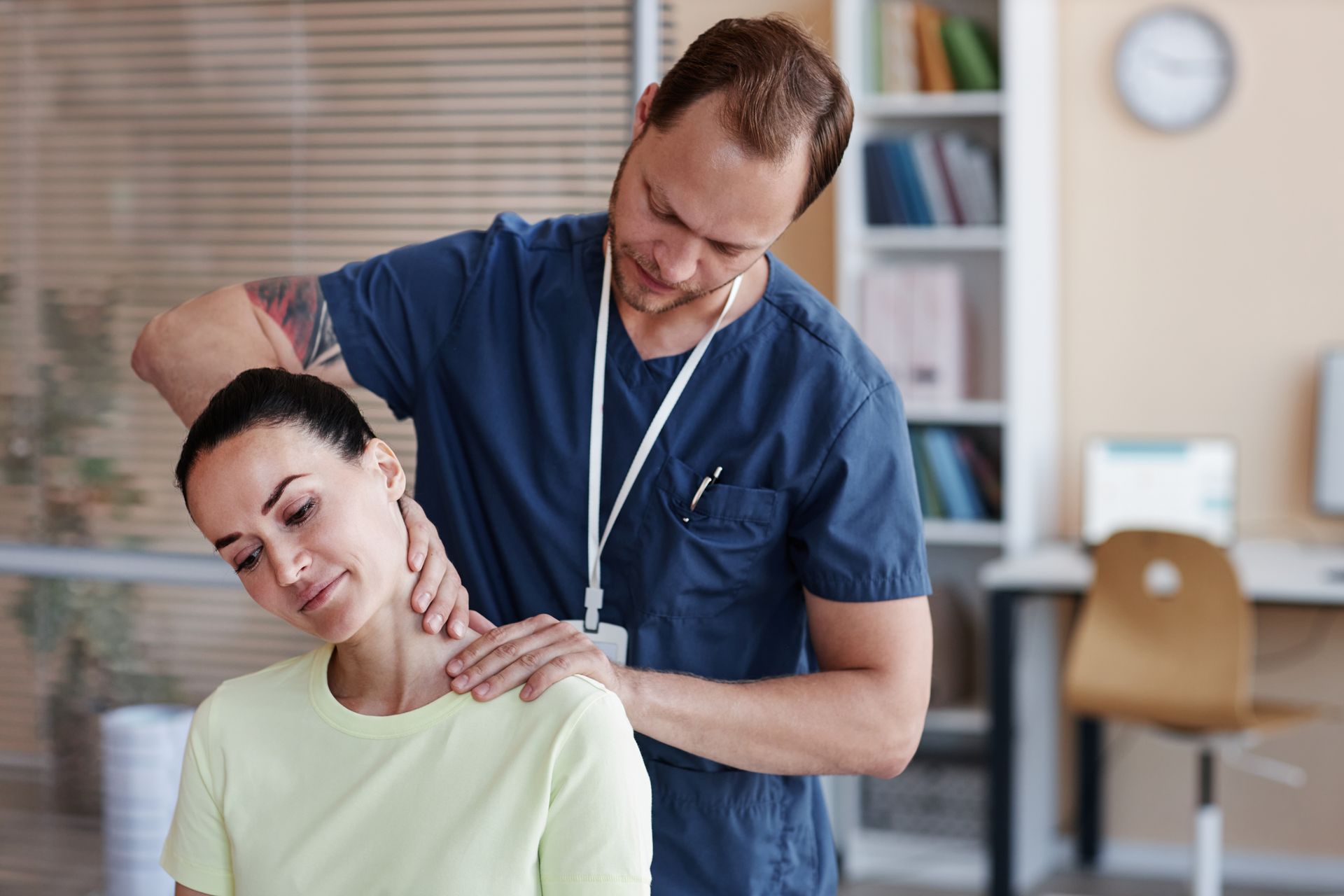 A chiropractor adjusting a woman's neck.