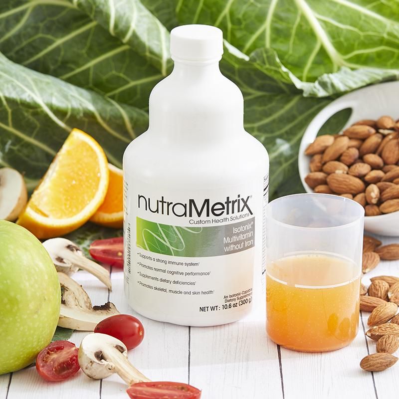A bottle of nutrametrix is surrounded by fruits and vegetables