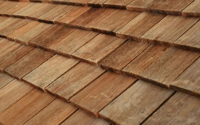 Close-up of a wood shingle roof with varying shades of brown.