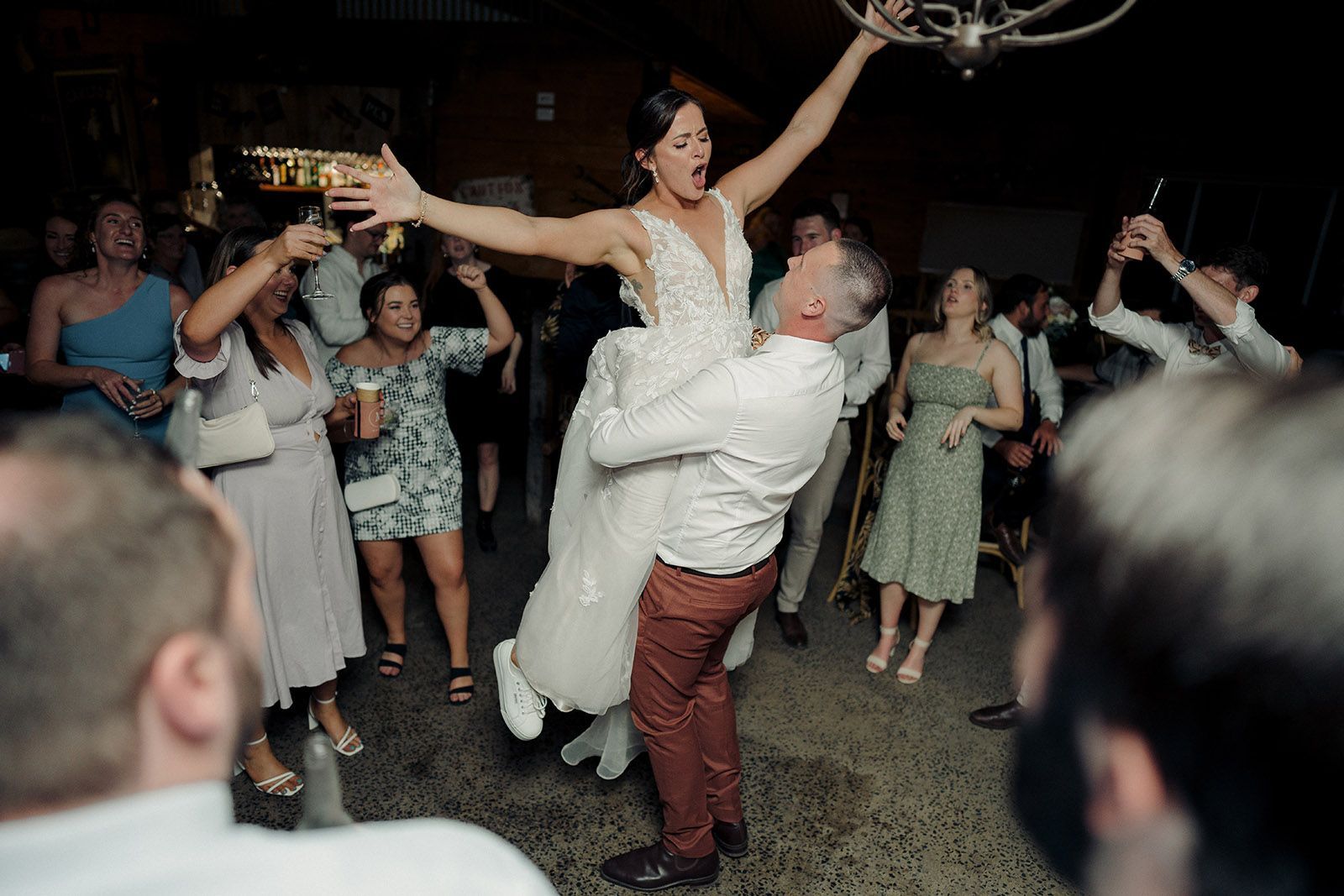 Bride being held in the air during a dance