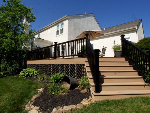 A house with a deck and stairs leading up to it