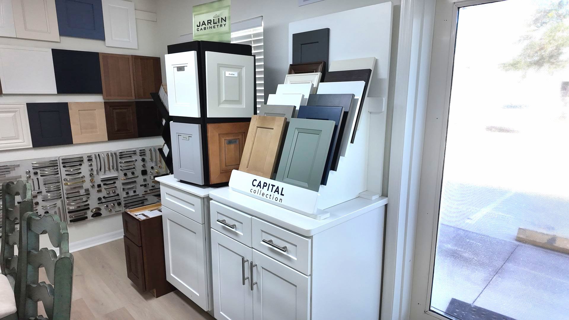 Kitchen cabinet display with various door samples. White cabinets with a variety of colors on display.