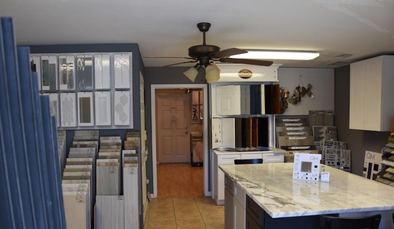Kitchen showroom featuring cabinet samples and a granite countertop island.