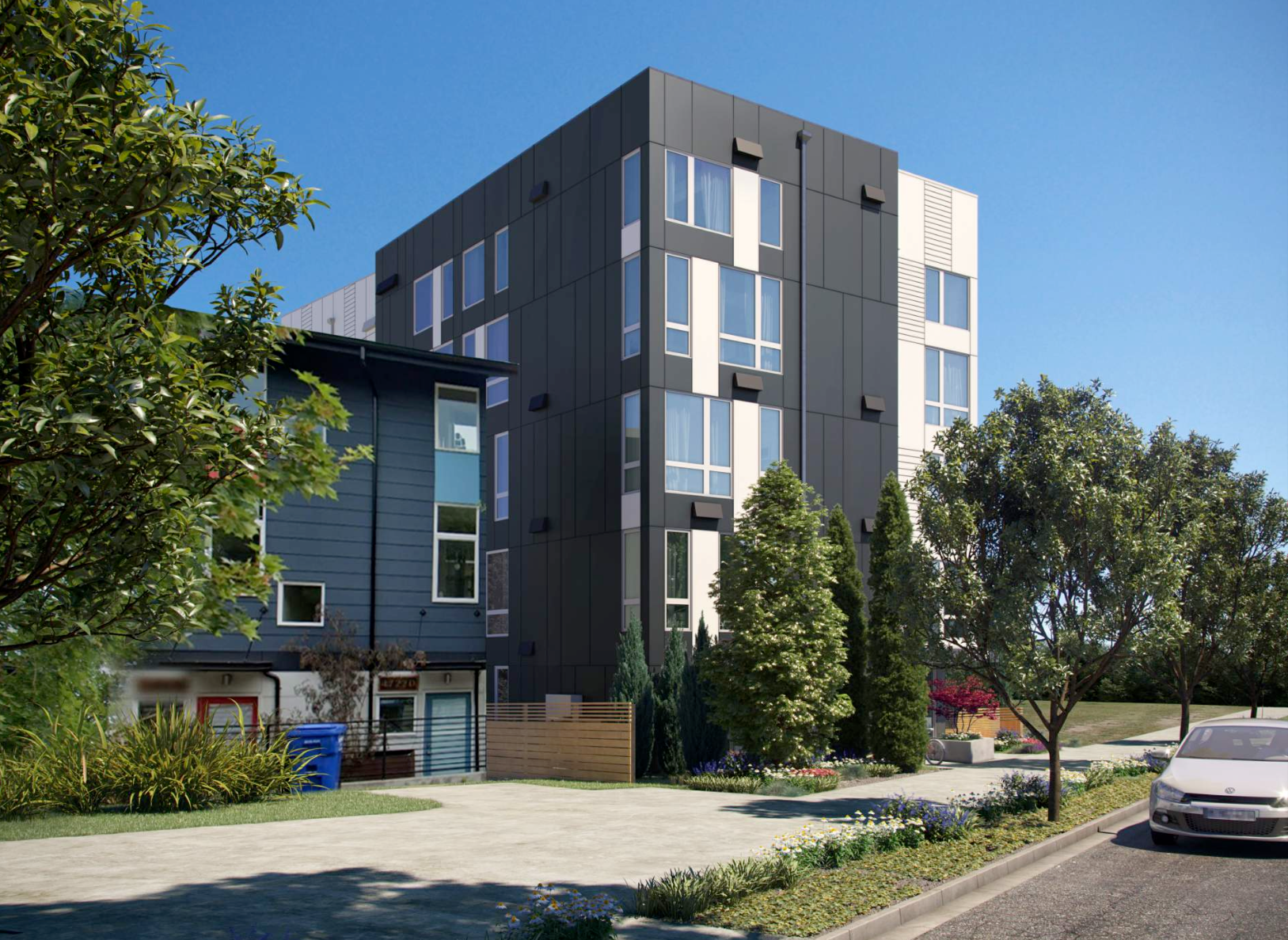Modern apartment building with dark and light panels, surrounded by trees and a sunny sky.
