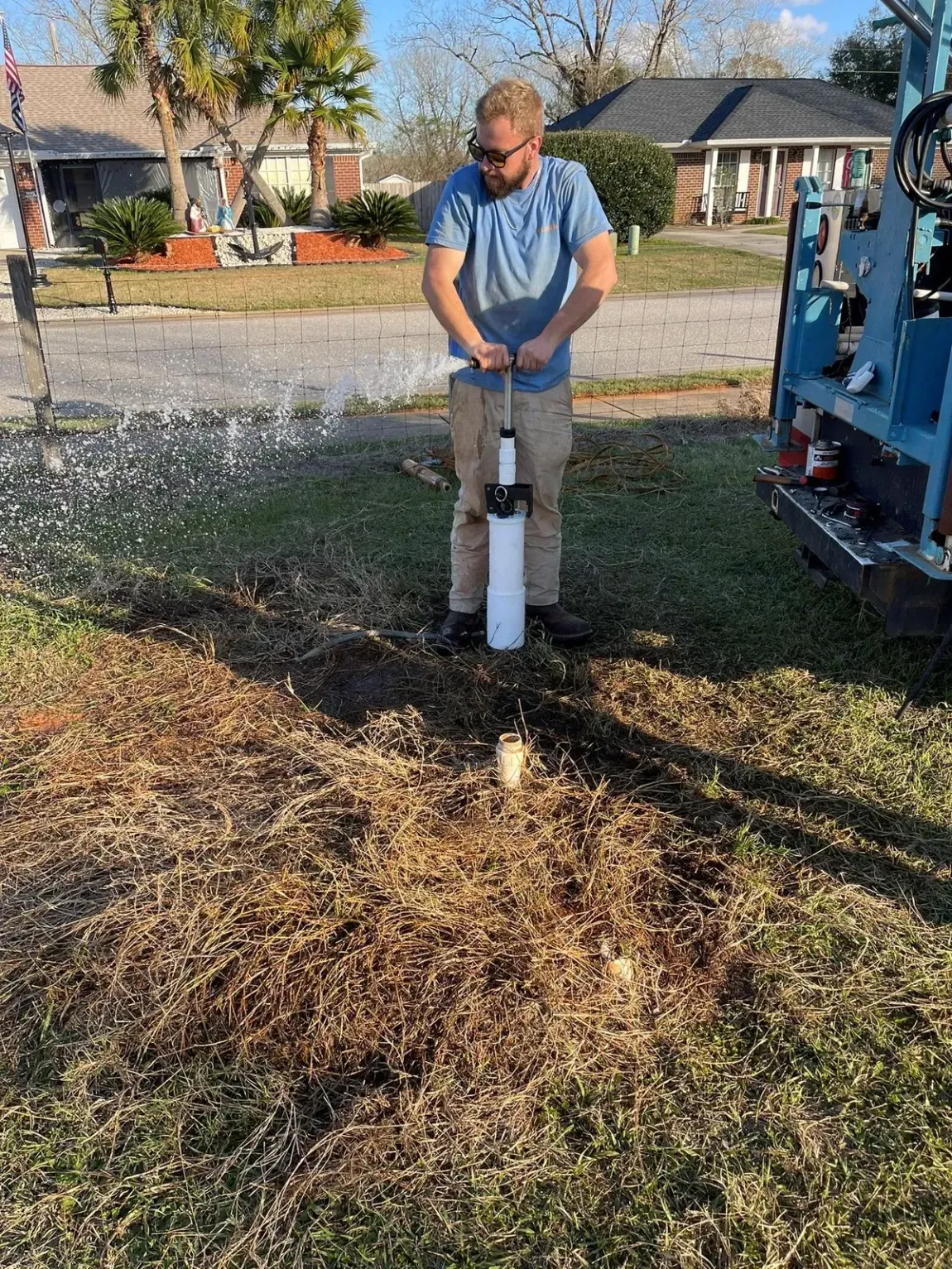 A water pump is attached to a blue pipe.
