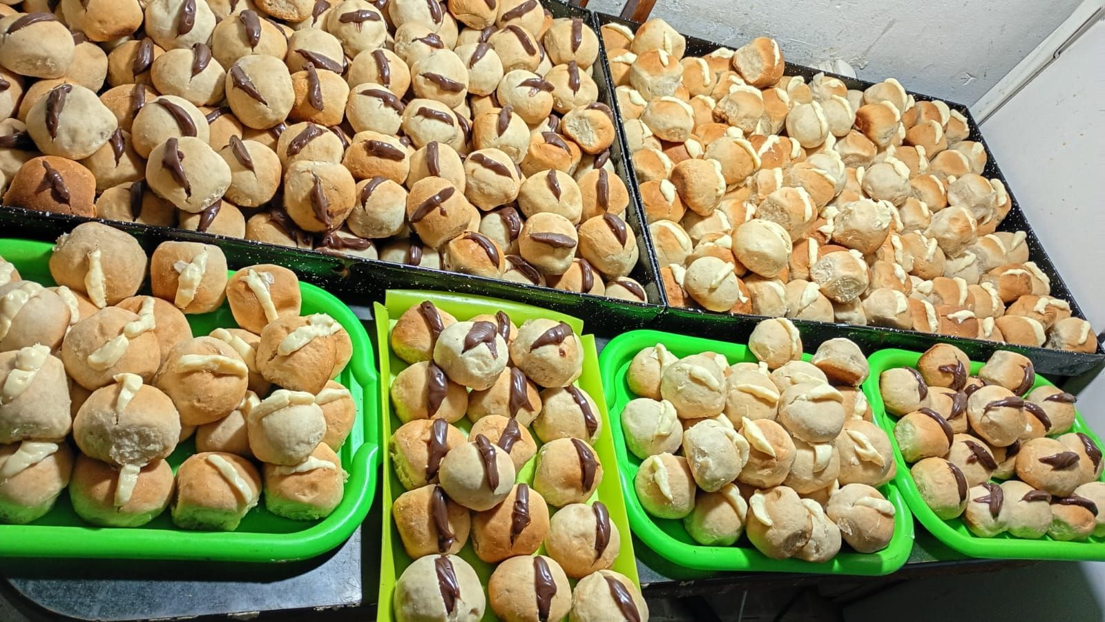 Niños en una mesa, mirando y manipulando comida en cuencos.