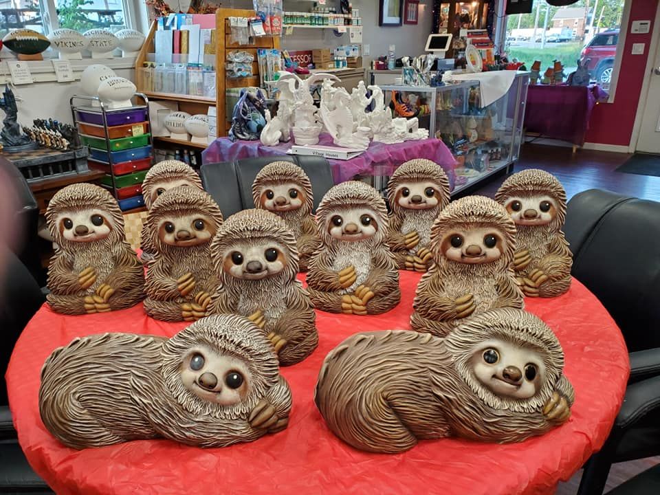 Mechanic assembling engine components in a workshop; black gloves, red overall.