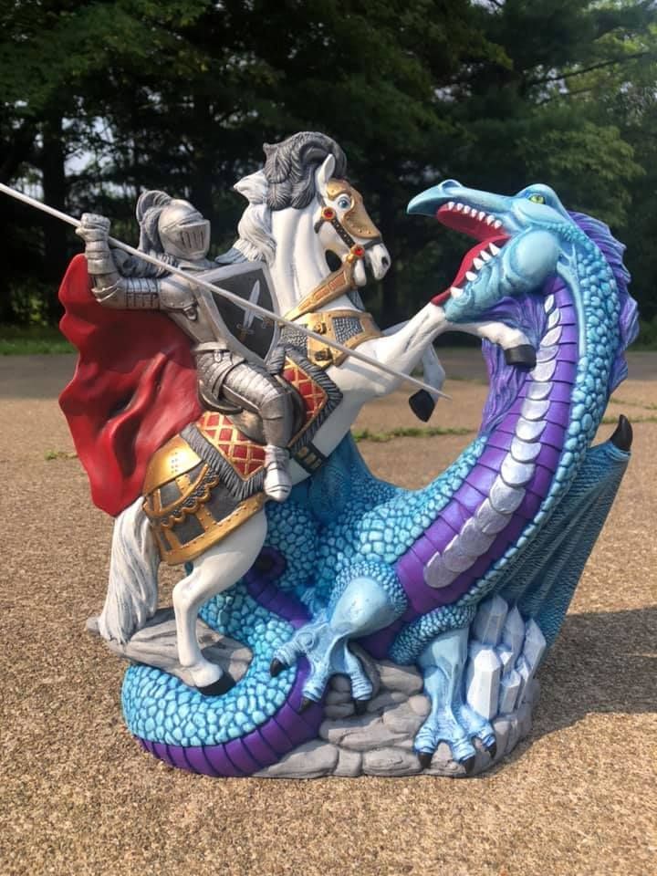 Mechanic lifts truck hood, revealing engine in a repair shop.