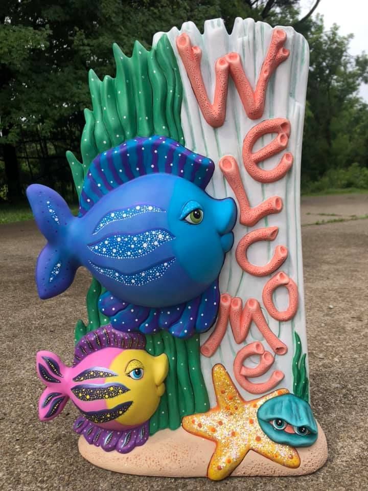 Red semi-truck in a dimly lit garage; a person stands near a lift.