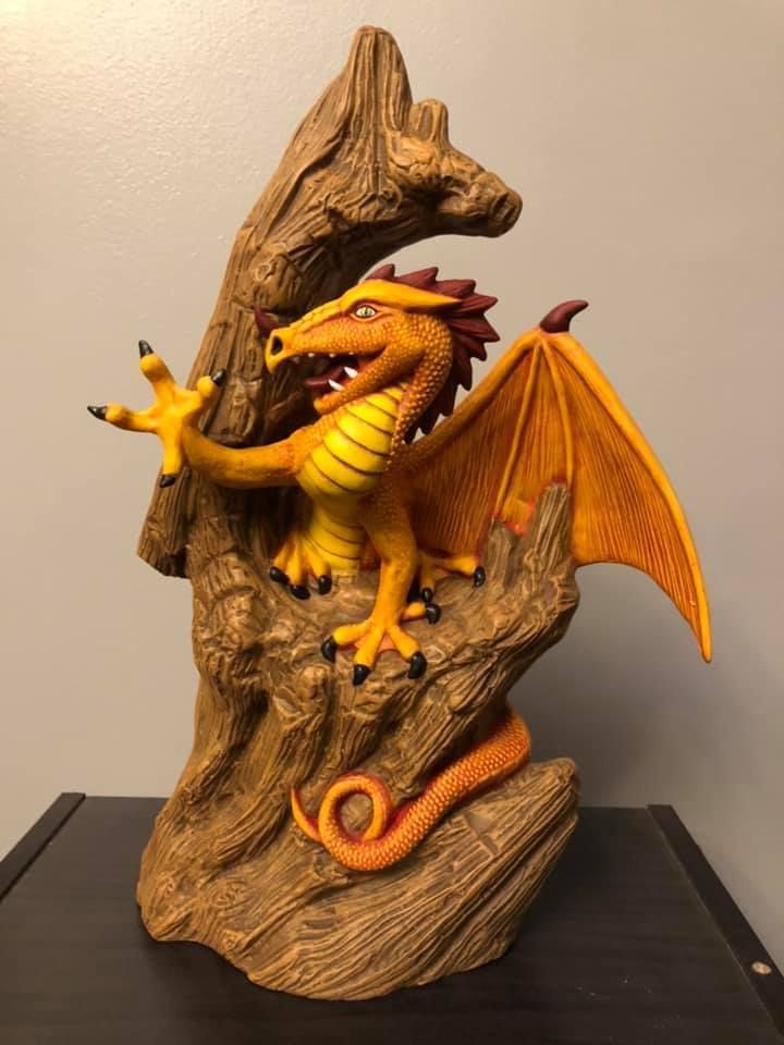 Open truck interior filled with stacked tires, tire changing machine, tools, and a ladder, outdoors.