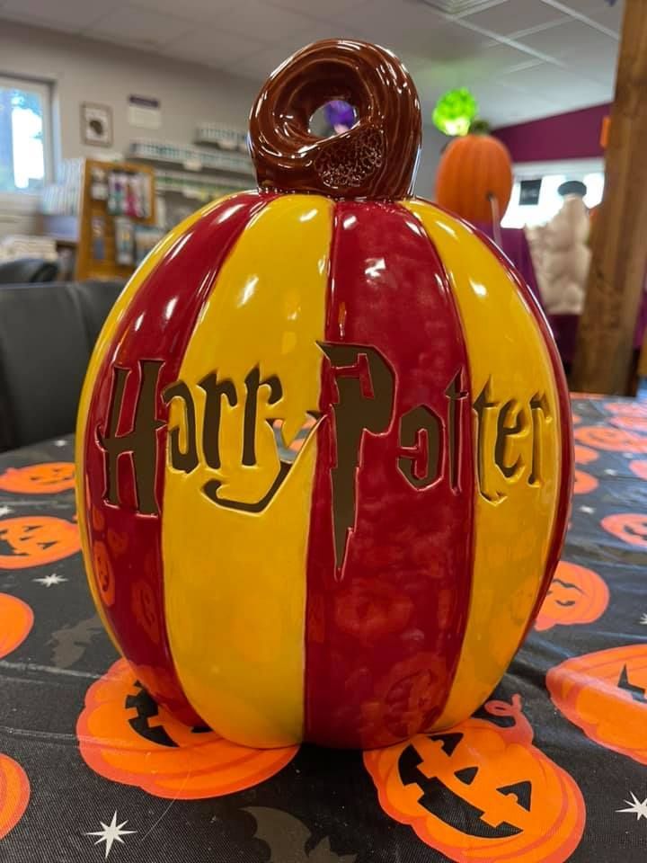 Harry Potter-themed pumpkin in red and yellow stripes, with the franchise's logo.