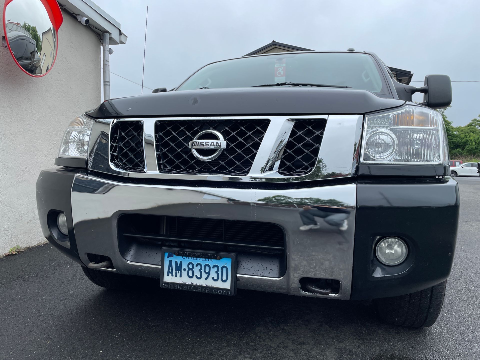 A black truck with repaired front bumper.