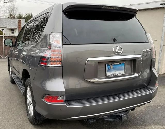 A gray lexus suv is parked in a parking lot.