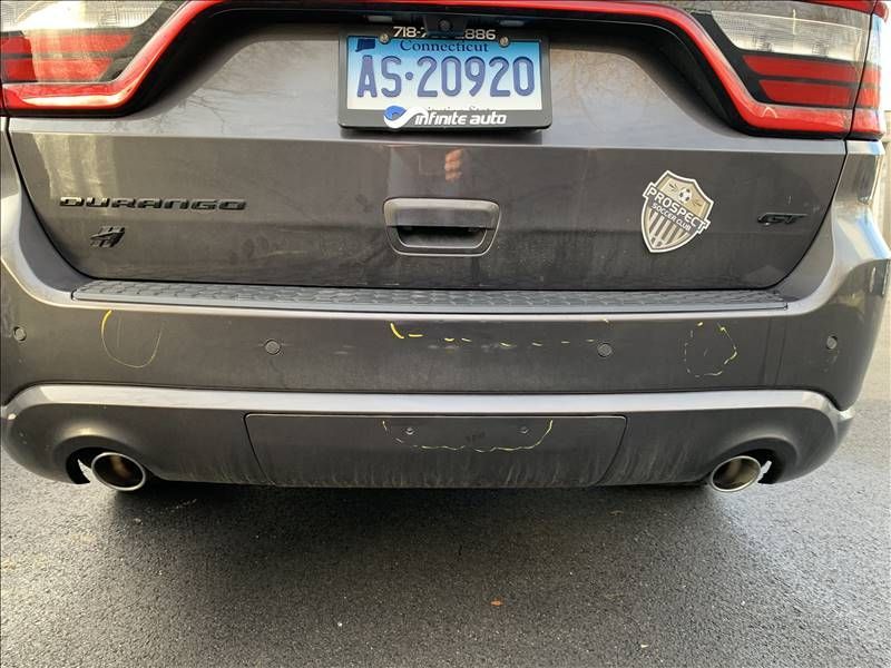 A car with rear bumper crash damage