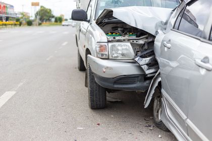 Two cars are involved in a car accident on the road.
