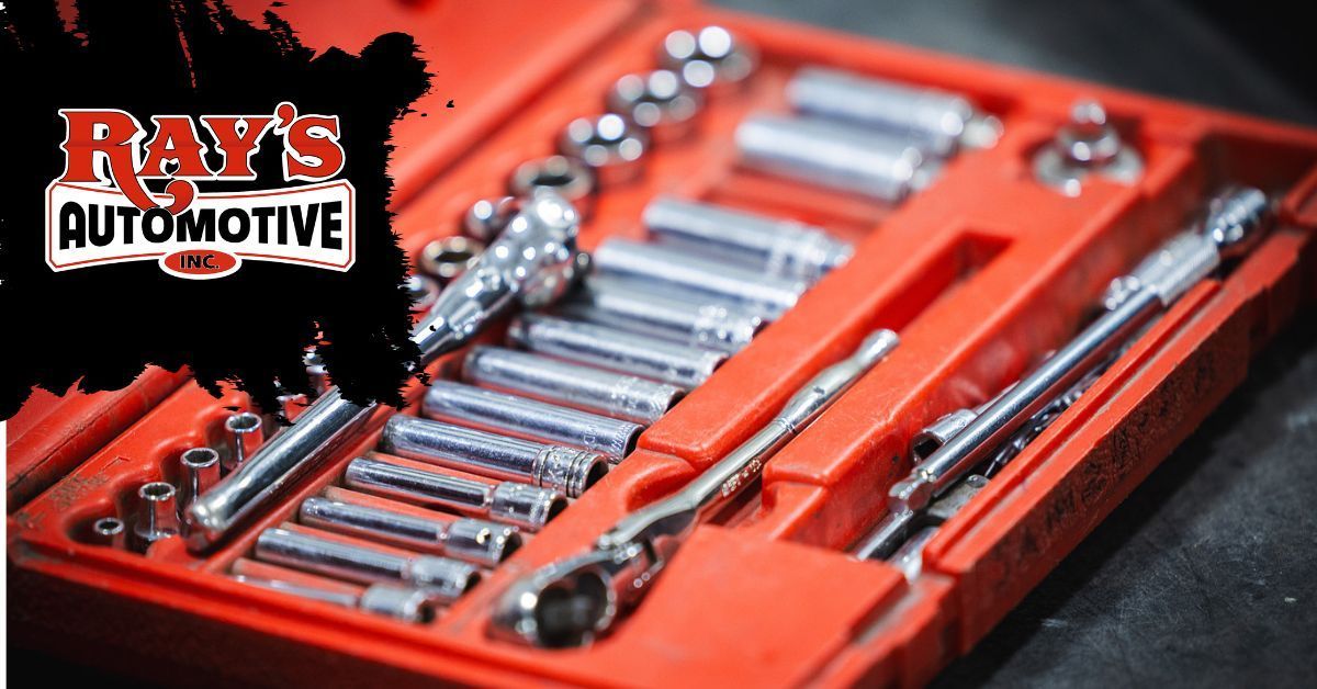 A red tool case filled with various silver metal socket wrenches and tools, with a Ray’s Automotive logo on the left.