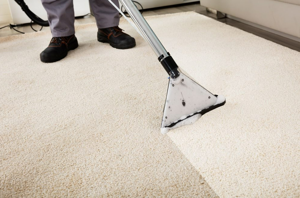 Man Cleaning Carpet with Vacuum Cleaner