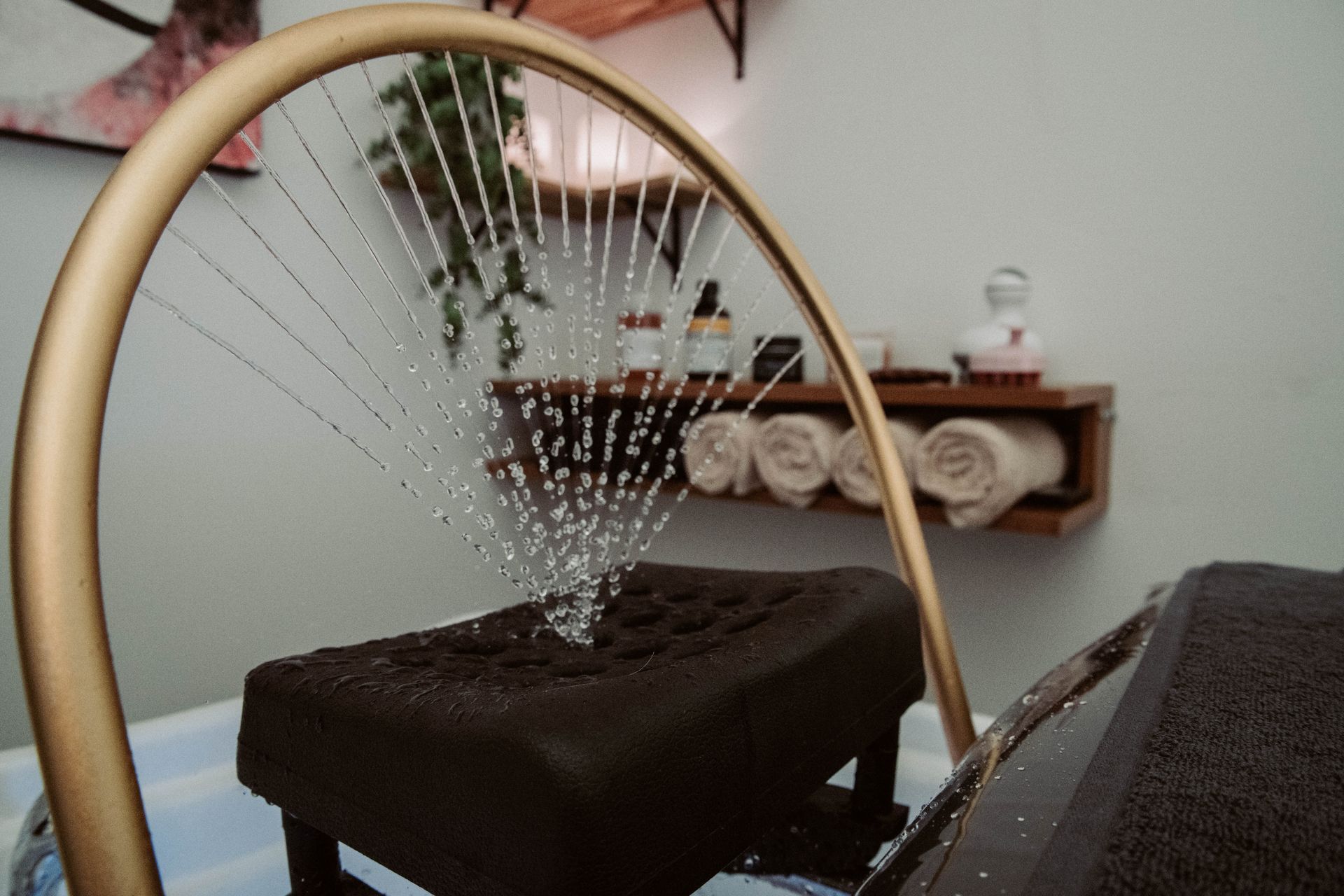 A sprinkler is spraying water on a table in a spa — Mjay's Hair Studio & Spa In Dubbo, NSW