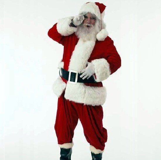 A man dressed as santa claus talking on a cell phone