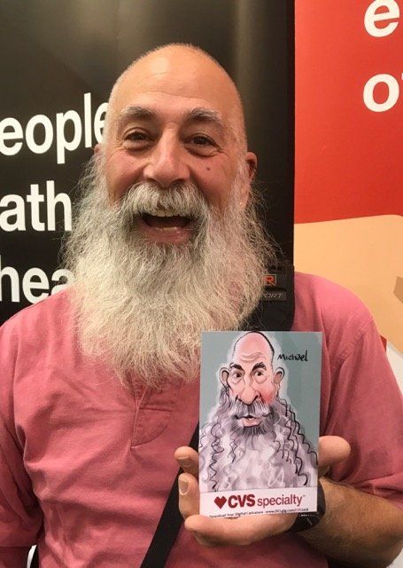 A man with a beard is holding a cvs specialty card