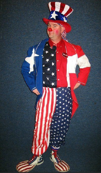 A clown dressed as uncle sam is standing with his hands in his pockets