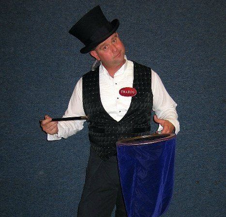 A man in a top hat has a name tag that says calvin