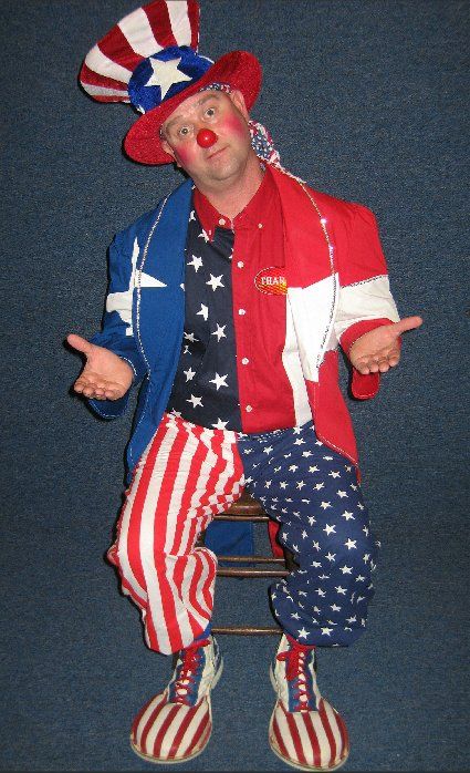 A man dressed as an american clown is sitting on a chair