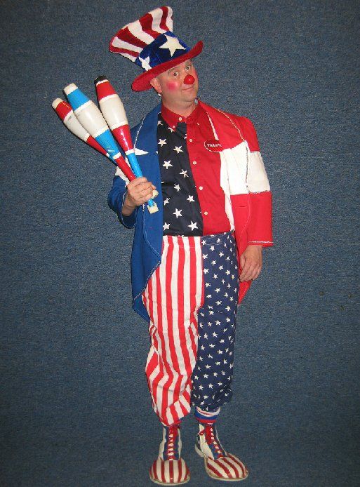 A clown in an uncle sam costume is holding juggling pins
