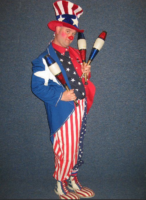 A clown dressed as uncle sam is holding juggling pins