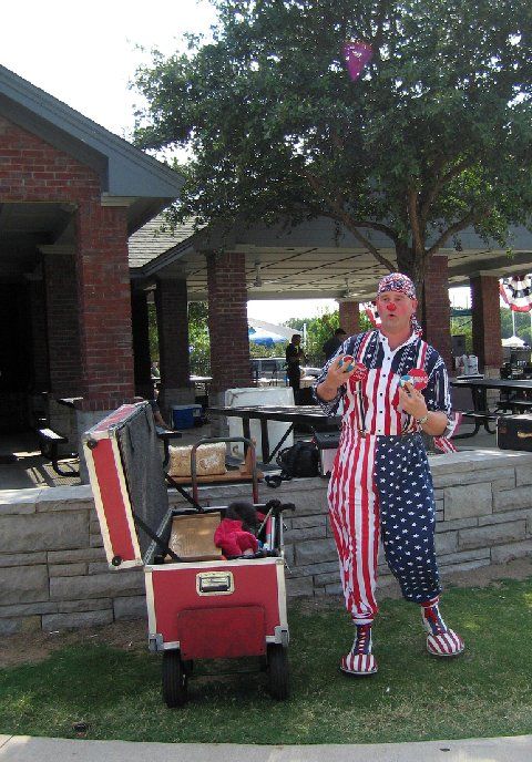 A man in an american flag outfit is standing next to a cooler