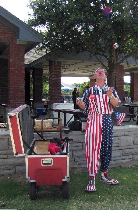 A man in an american flag outfit is juggling balloons