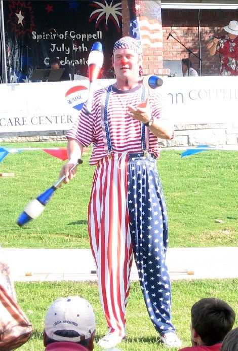 A man in a red white and blue outfit is juggling a ball