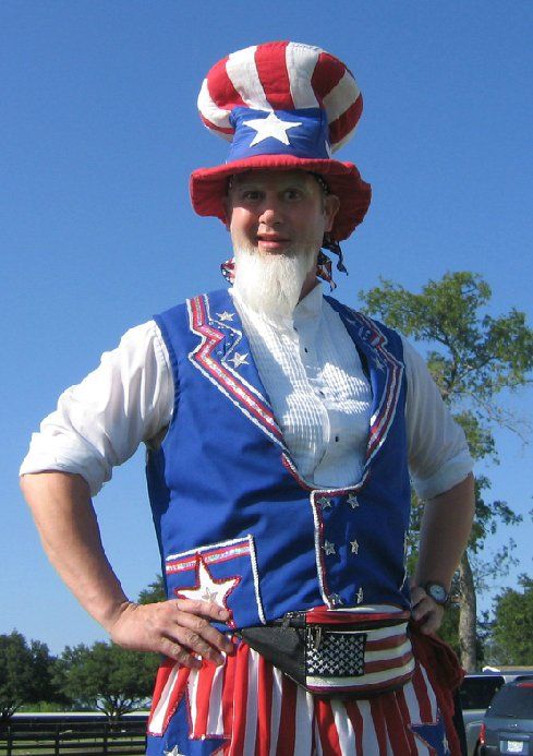 A man in an uncle sam costume stands with his hands on his hips