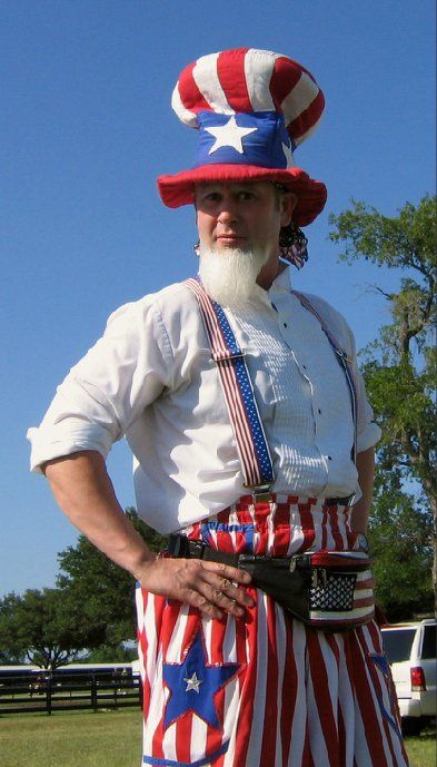 A man with a beard is dressed as uncle sam