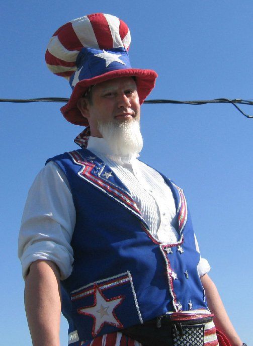 A man in an uncle sam costume with a red white and blue hat