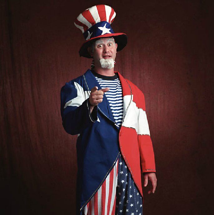 A man dressed as uncle sam is pointing at the camera
