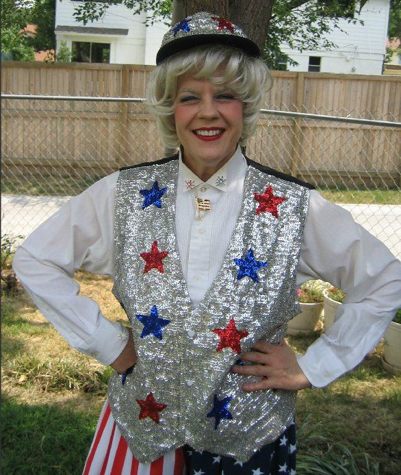 A woman in an uncle sam costume is smiling with her hands on her hips